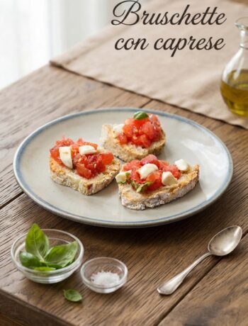 piatto di brUschette con caprese e foglie di basilico